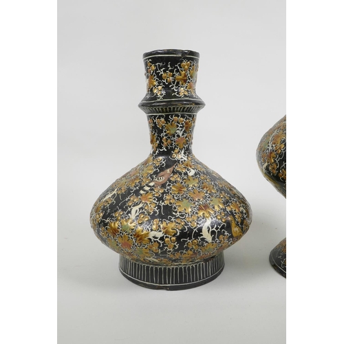 41 - A Kashmiri papier mâché and brass hookah base, and another similar, decorated with birds amongst gil... 