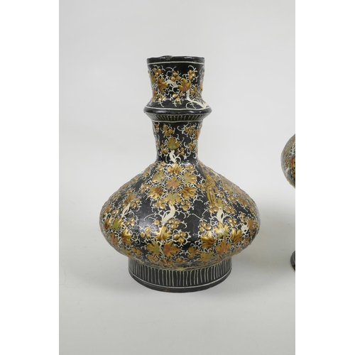 41 - A Kashmiri papier mâché and brass hookah base, and another similar, decorated with birds amongst gil... 