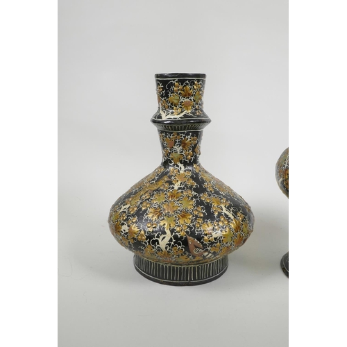 41 - A Kashmiri papier mâché and brass hookah base, and another similar, decorated with birds amongst gil... 