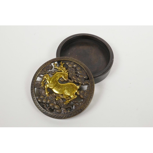 45 - A Chinese bronze cylinder incense box with a pierced cover decorated with a gilt deer, 4½