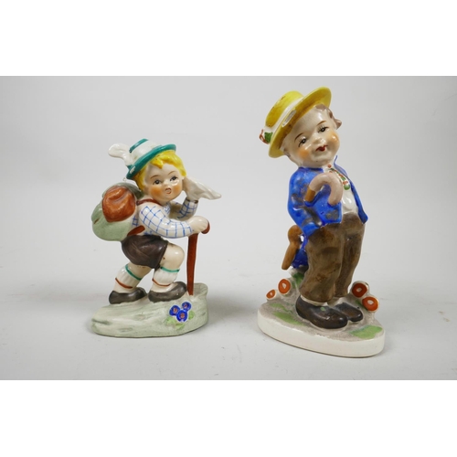 49 - Two 1950s Goebel Hummel style figures, one of a German boy mountaineering, and another of a boy in t... 