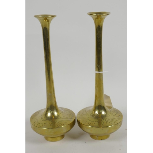 66 - A pair of Chinese brass long necked specimen vases having engraved decoration of dragons, 8½