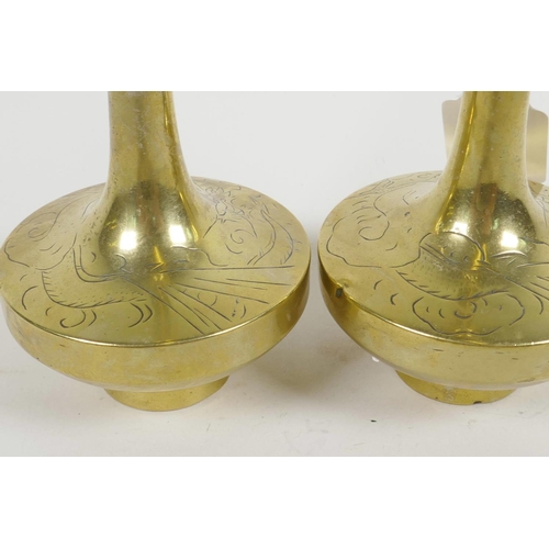 66 - A pair of Chinese brass long necked specimen vases having engraved decoration of dragons, 8½