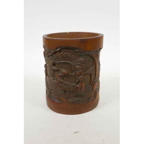 70 - A Chinese carved bamboo brush pot decorated with figures in a landscape, 6½