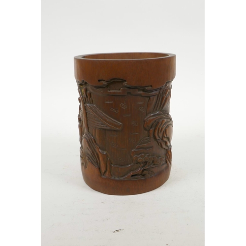 70 - A Chinese carved bamboo brush pot decorated with figures in a landscape, 6½