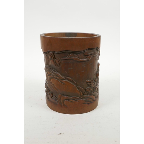 70 - A Chinese carved bamboo brush pot decorated with figures in a landscape, 6½