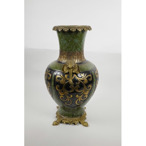 63 - A Chinese mottled green ground pottery vase with ormolu style mounts and elephant mask handles, the ... 