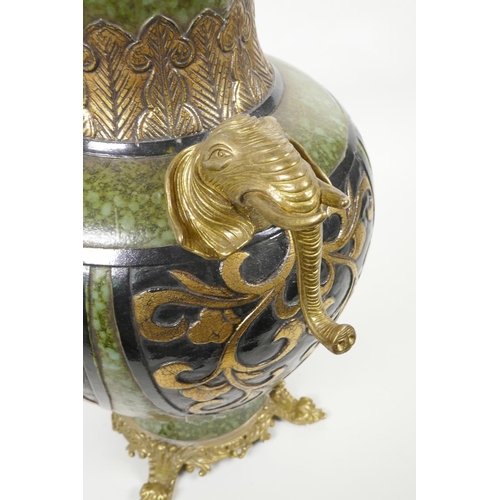 63 - A Chinese mottled green ground pottery vase with ormolu style mounts and elephant mask handles, the ... 