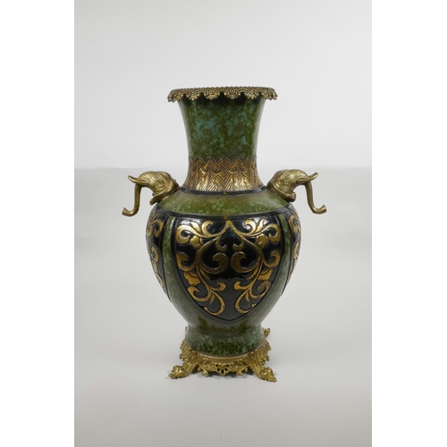 63 - A Chinese mottled green ground pottery vase with ormolu style mounts and elephant mask handles, the ... 