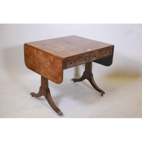 1858 - A Regency mahogany sofa table with two true and two false drawers raised on end supports, 33