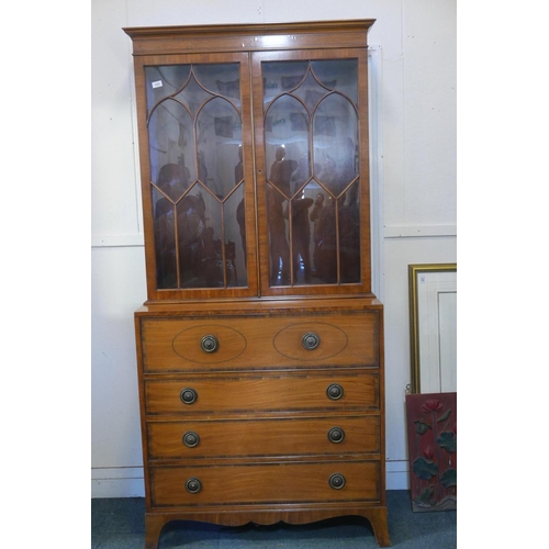 1863 - A Regency style satinwood secretaire bookcase, with astragl glazed top, base with interior fitted wi... 