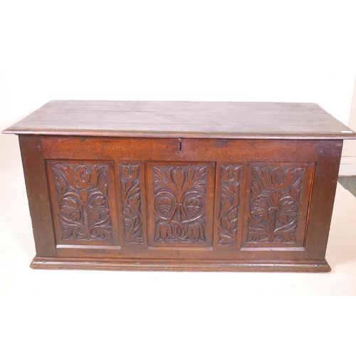 1864 - An C18th oak triple panel coffer with carved decoration, 55