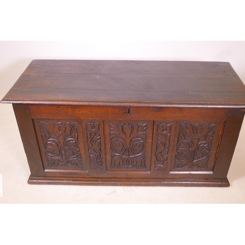 1864 - An C18th oak triple panel coffer with carved decoration, 55