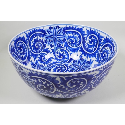 10 - A large blue and white porcelain bowl with scrolling floral decoration, 14