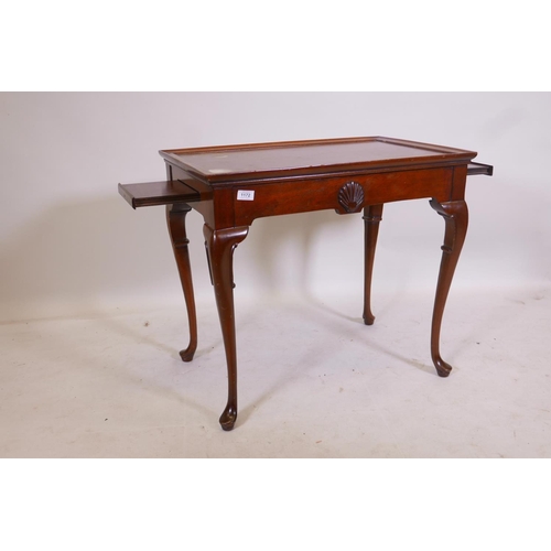 1172 - A Georgian style mahogany slider table, with pull out end slides and tray top, raised on carved cabr... 