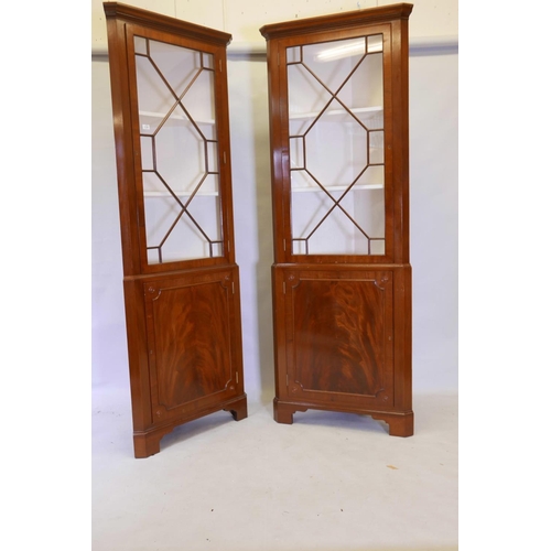 1175 - A good pair of Regency style figured mahogany corner display cabinets, the tops with astragal glazed... 