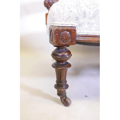 1176 - A Victorian walnut open arm settee with carved decoration and bow front, raised on turned, fluted su... 