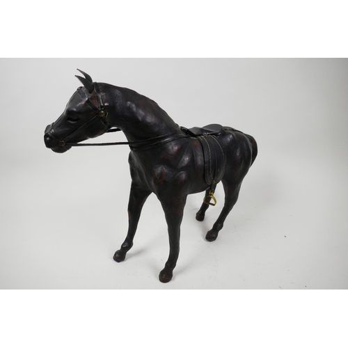 12 - A leather horse with saddle and reins, 10½