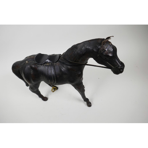 12 - A leather horse with saddle and reins, 10½