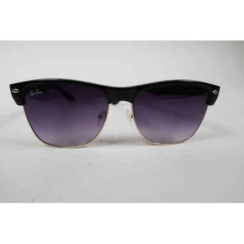 18 - A pair of RayBan sunglasses with black frames and mauve tinted glass in a Lipsy of London hard case