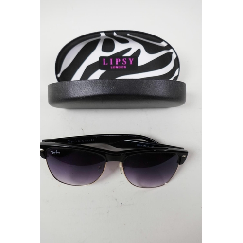 18 - A pair of RayBan sunglasses with black frames and mauve tinted glass in a Lipsy of London hard case