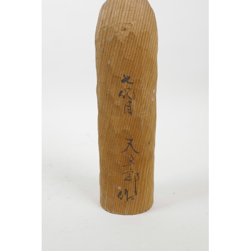 21 - A collection of four Japanese carved and turned wood Kokeshi dolls, signed to the base and sides, 9½... 