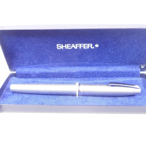 22 - A Sheaffer fountain pen together with a Parker ball point pen and pencil set