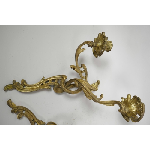 26 - A pair of ormolu two light wall sconces of scrolling leaf design, 17