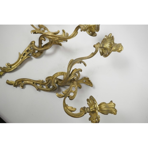 26 - A pair of ormolu two light wall sconces of scrolling leaf design, 17