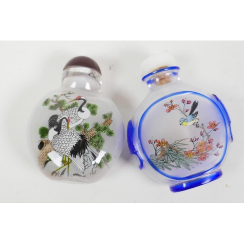 43 - Two Peking glass snuff bottles with reverse decoration of cranes and a figure, 2½