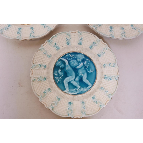 50E - Three C19th French faience plates with putti decoration, in the style of Rupelle, impressed to base ... 