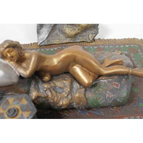 14 - A cold painted bronze figure of a girl lying on a bed, 6¼