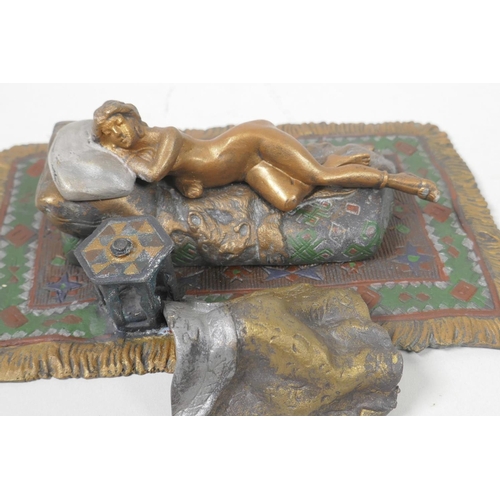 14 - A cold painted bronze figure of a girl lying on a bed, 6¼