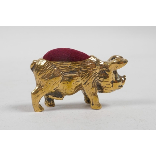 21 - A brass pincushion in the form of a pig, 1½