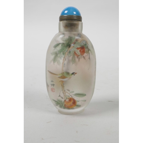 22 - A Chinese reverse decorated snuff bottle depicting birds amongst flowers and gourds, 3½