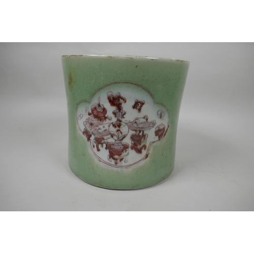 25 - A Chinese porcelain brush pot decorated with panels in puce on a green glaze, 7½