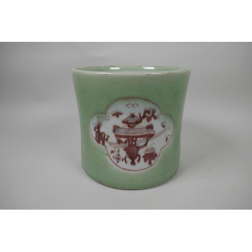 25 - A Chinese porcelain brush pot decorated with panels in puce on a green glaze, 7½