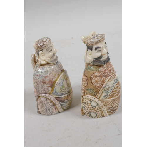 31 - A pair of Chinese bone snuff bottles in the form of two dignitaries, with inked engraved decoration,... 