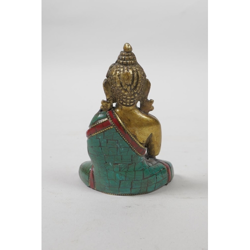 46 - A Tibetan brass Buddha with a stone inset robe, 3