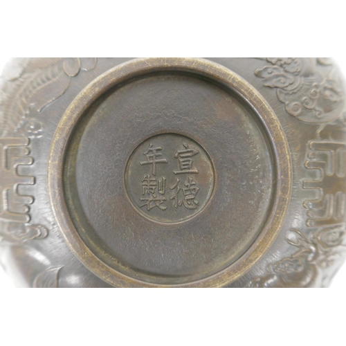 48 - A Chinese bronze trinket bowl with raised kylin decoration, 4 character mark to base, 7