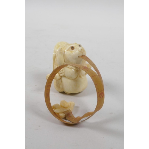 51 - A bone tape measure carved in the form of a bear, 2