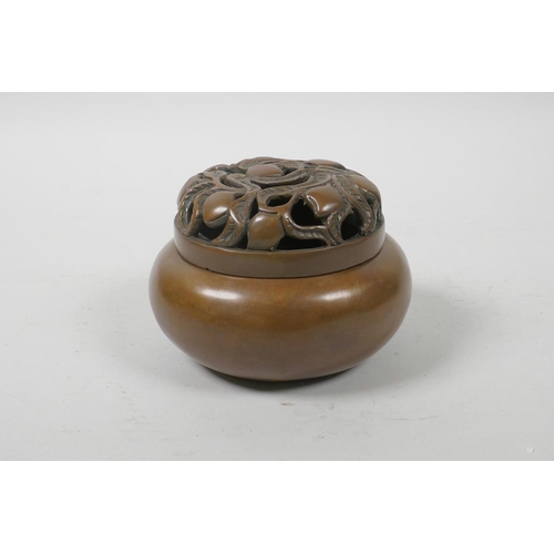 52 - A Chinese bronze censer and cover, with pierced peach tree decoration, impressed mark to base, 4