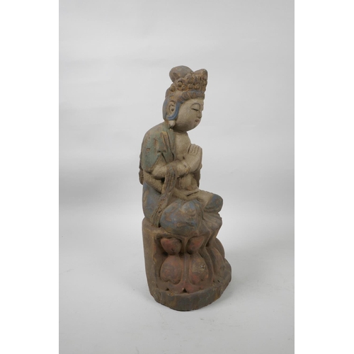 56 - A Chinese painted and distressed carved wood Buddha seated on a lotus throne, 14½