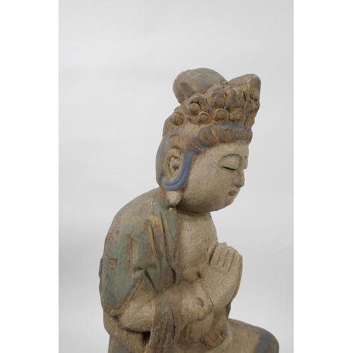 56 - A Chinese painted and distressed carved wood Buddha seated on a lotus throne, 14½