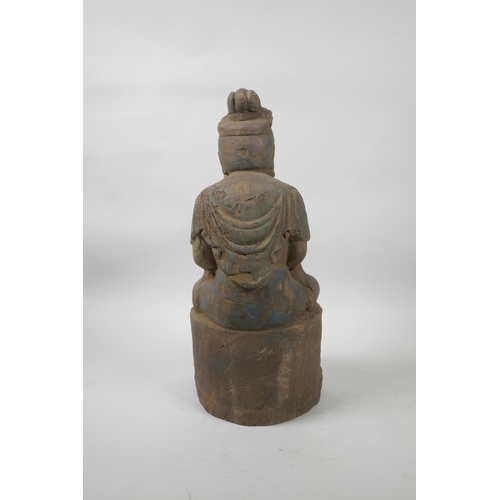 56 - A Chinese painted and distressed carved wood Buddha seated on a lotus throne, 14½