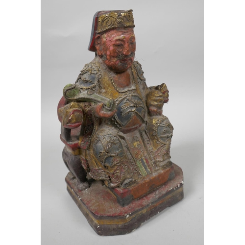 9 - A Chinese painted wooden figure of a dignitary wearing fine robes with wired decoration, seated on a... 