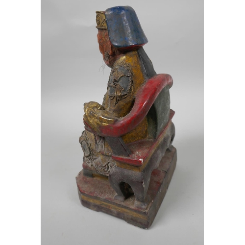 9 - A Chinese painted wooden figure of a dignitary wearing fine robes with wired decoration, seated on a... 