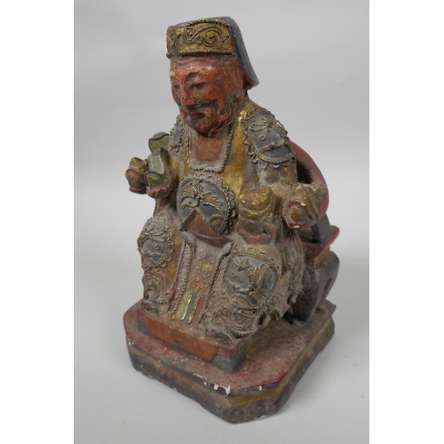 9 - A Chinese painted wooden figure of a dignitary wearing fine robes with wired decoration, seated on a... 