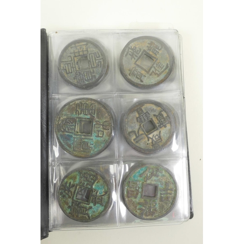 13 - A wallet of Chinese facsimile (replica) bronze coinage, 1½