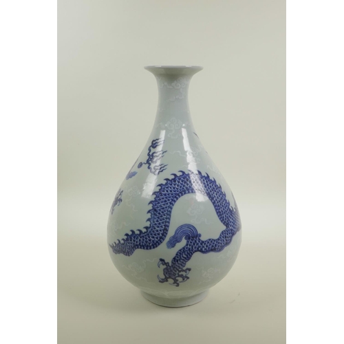 18 - A Chinese blue and white porcelain pear shaped vase decorated in the Ming style depicting dragons ch... 